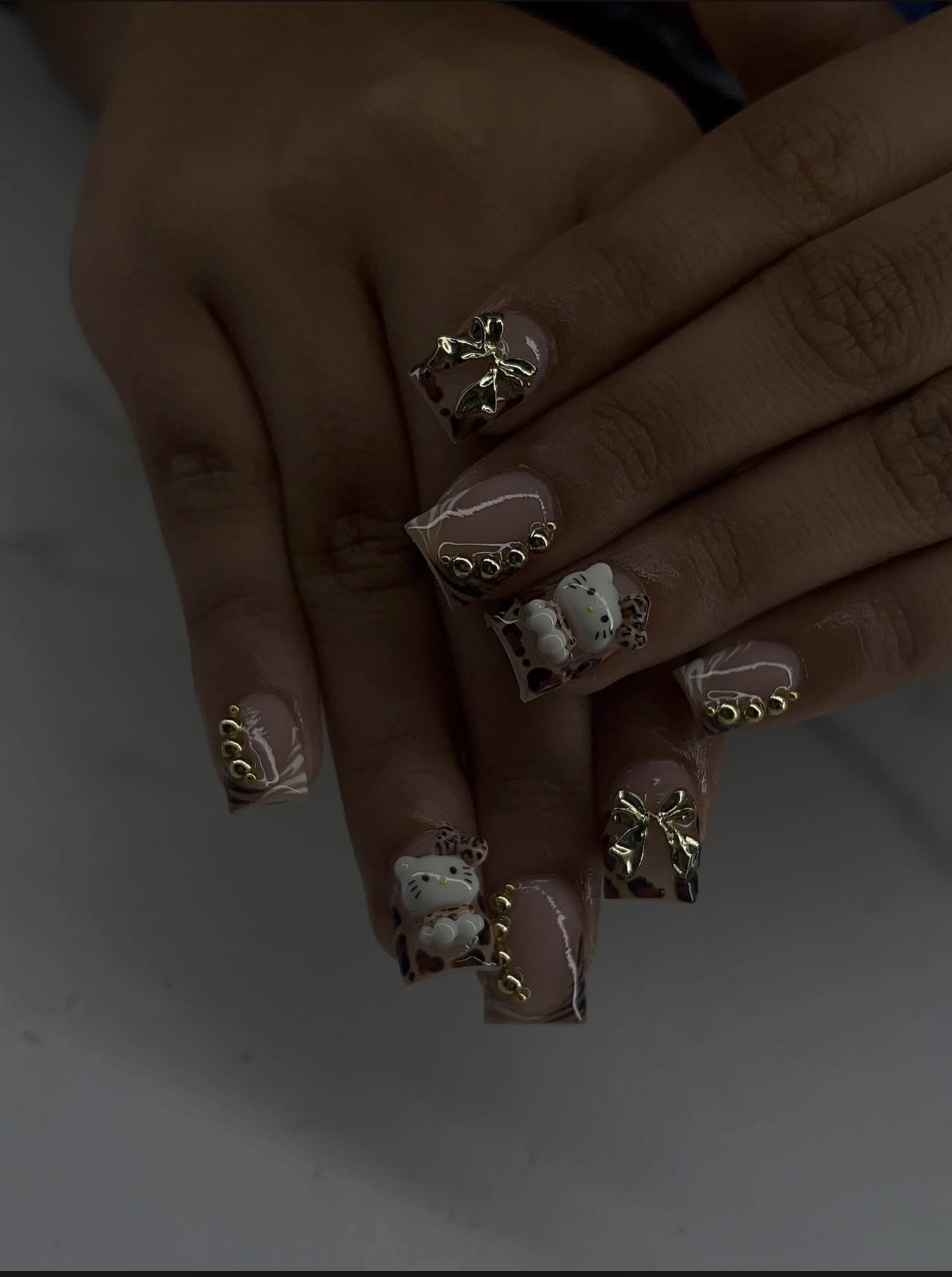 Nude tips with leopard French, 3D Hello Kitty charms & gold bows